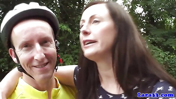 Wanita berambut coklat sedang menjilat satu sama lain sambil berkongsi pejantan hitam itu